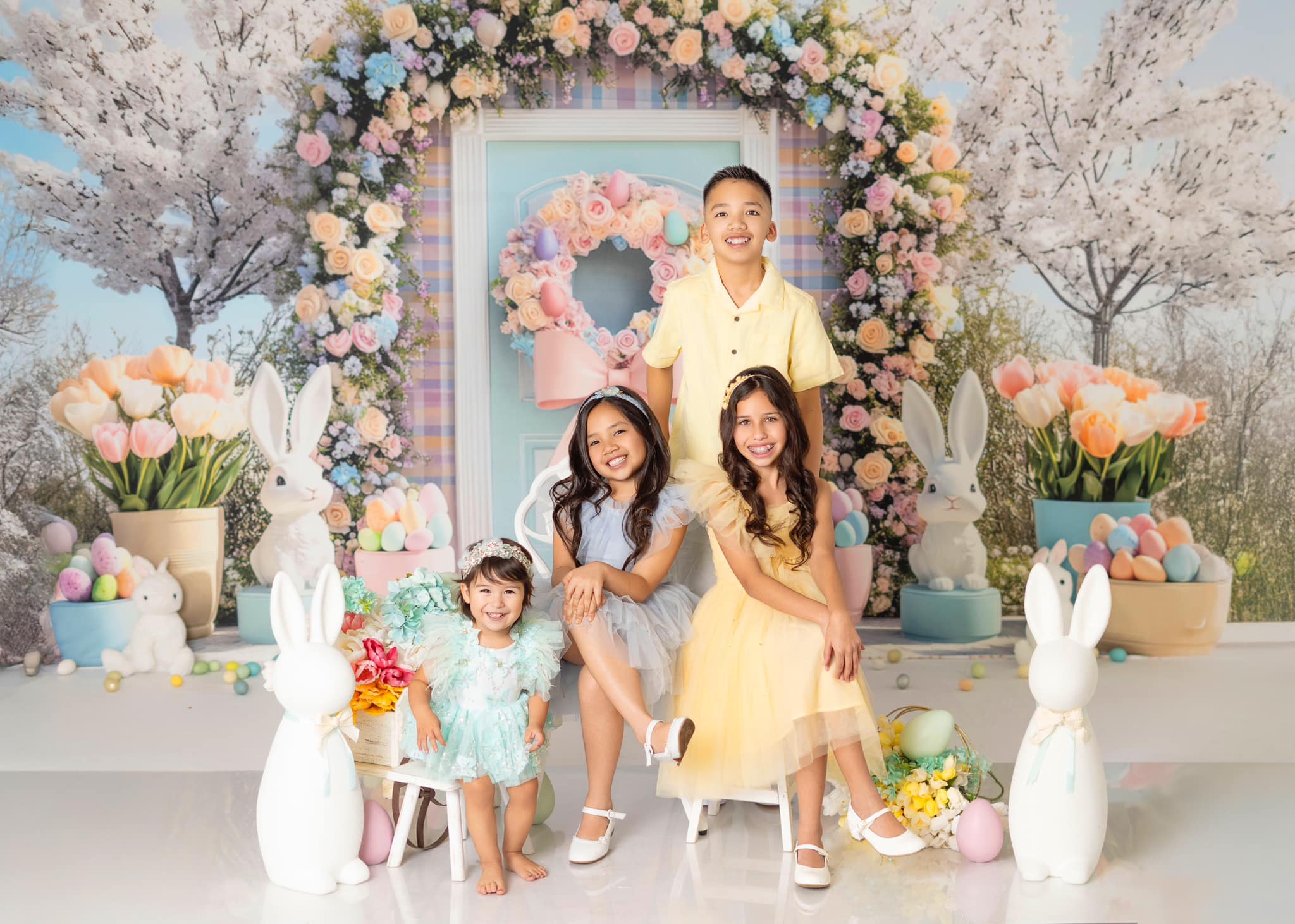 Kate Easter backdrop with floral arch, white bunnies, and pastel decor for spring photos