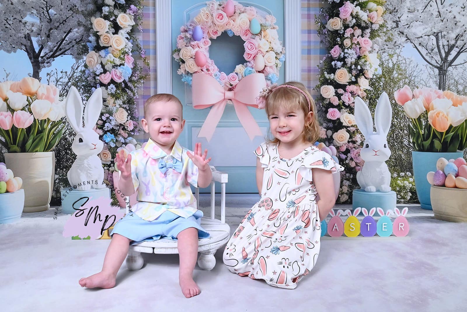 Easter backdrop with floral arch, decorative bunnies, and pastel spring decor by Mini MakeBelieve