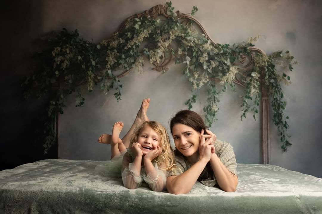 Mom and me in front of the Greenery Headboard Backdrop