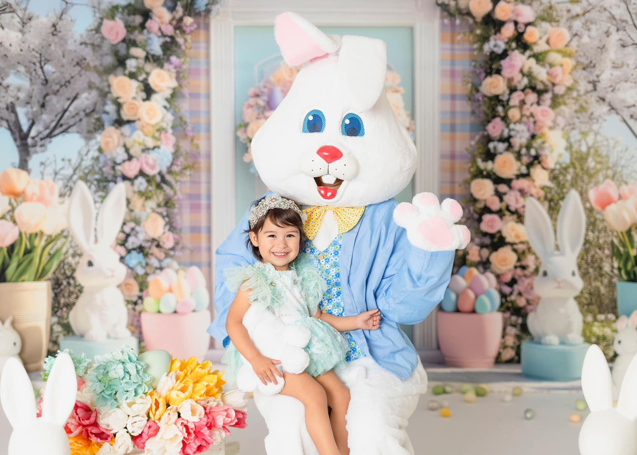 Easter outdoor scene with bunny character in blue outfit and floral arch backdrop by Mini MakeBelieve, featuring spring decorations