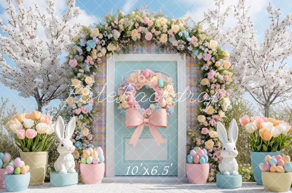 Easter backdrop with floral arch, white bunnies, pastel eggs, and spring blooms against blue door - Kate Easter Outdoor Bunny Backdrop