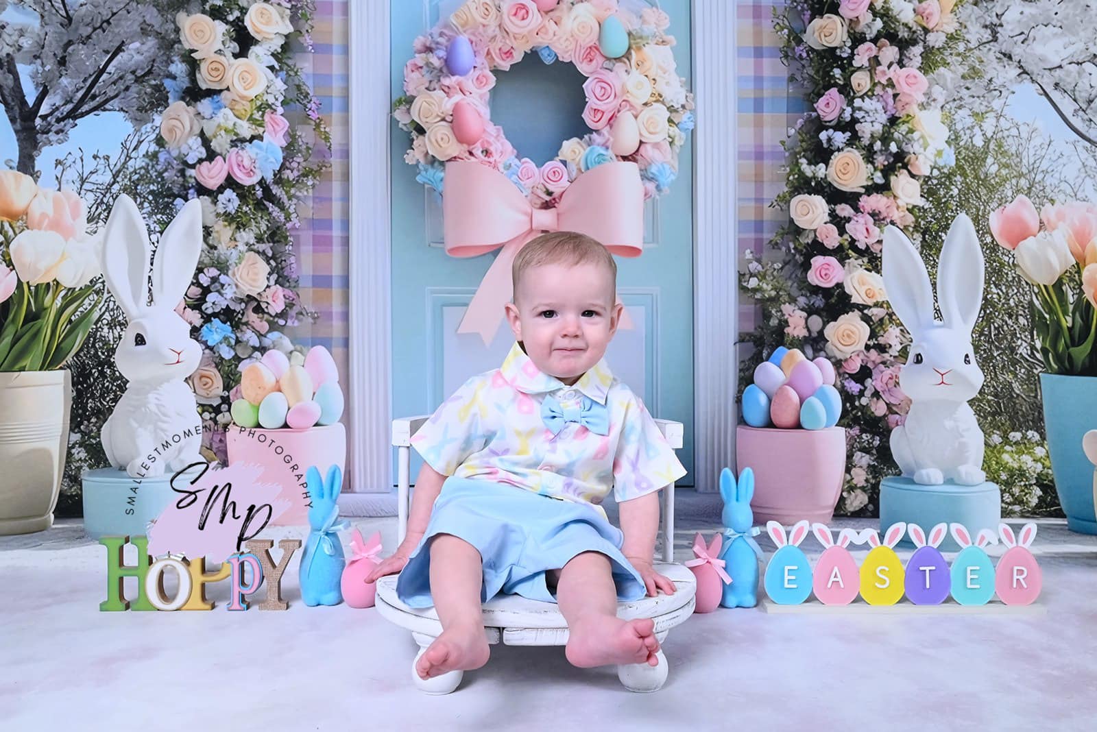 Easter outdoor scene with floral arch backdrop, decorative bunnies, pastel eggs, and spring flowers by Mini MakeBelieve