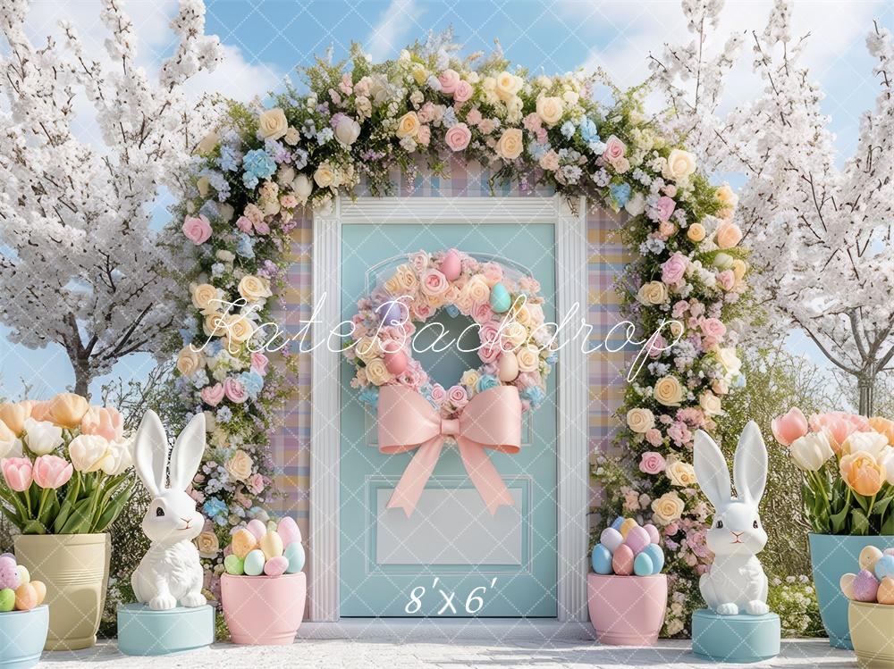 Easter floral arch backdrop with bunnies, pastel eggs, and spring flowers, featuring blue door and pink bow for Kate Easter collection