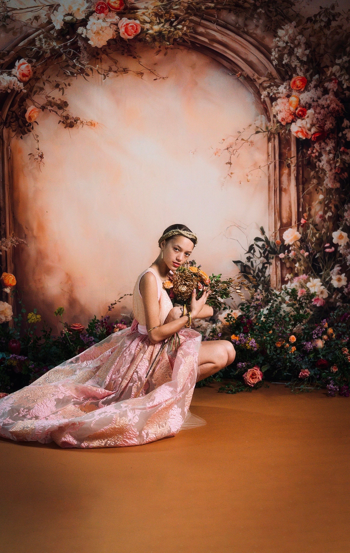 A girl holding flowers squats in front of Beige Flower Wall Spring Fleece Backdrop